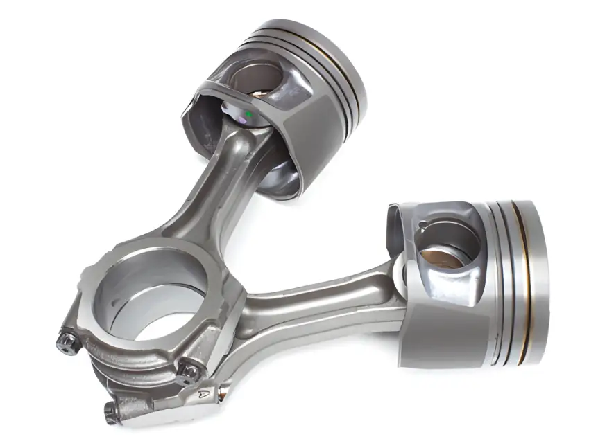 A pair of piston rings and engine parts coated by ARKA, designed for durability in high-speed applications and protection against extreme temperatures.