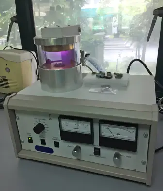 A laboratory sputter coater machine used for coating samples with a thin metal layer for scanning electron microscopy (SEM) analysis.