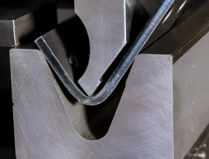 Close-up of metal forming process using PVD-coated extrusion dies to reduce galling and downtime